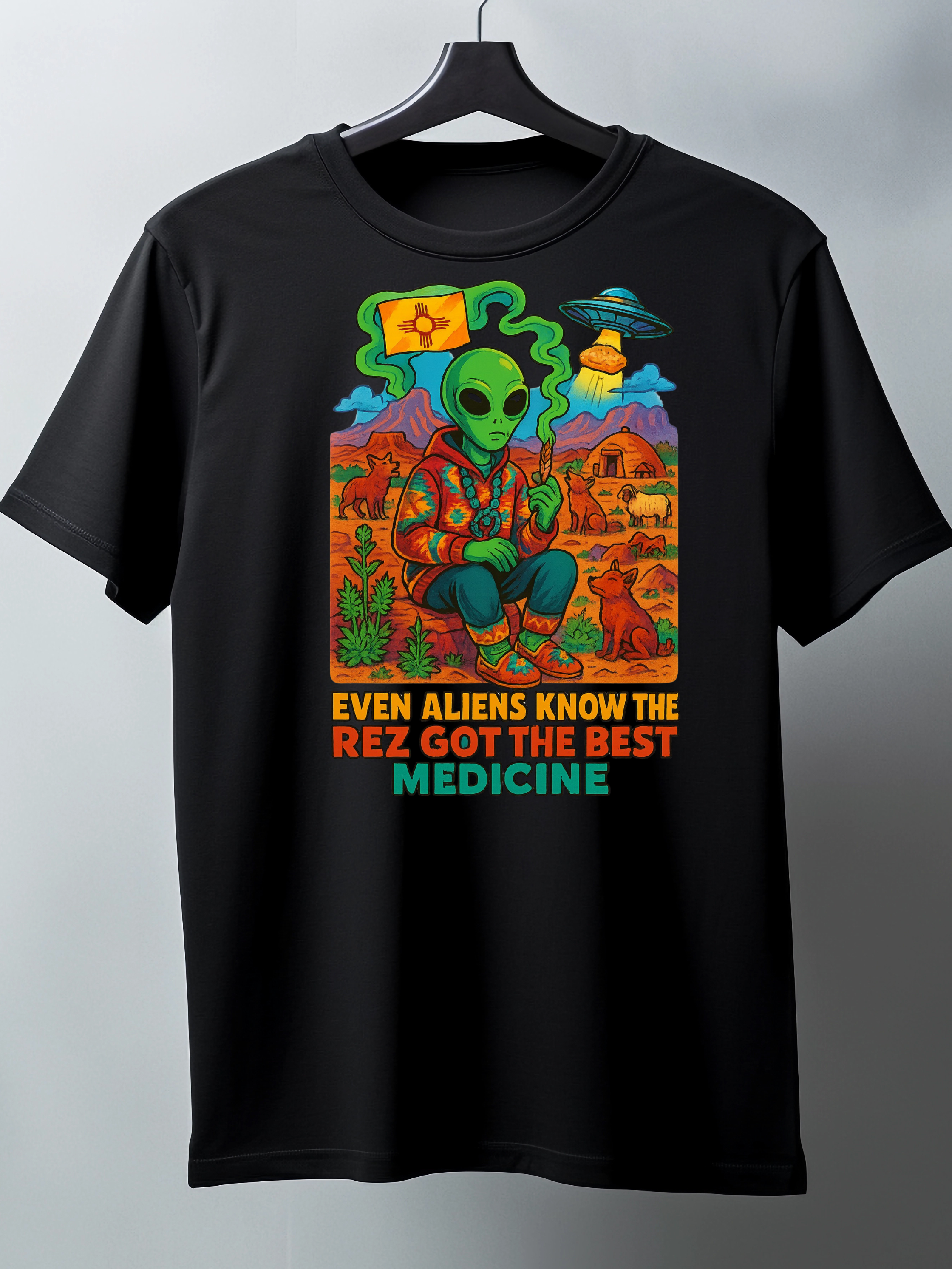 Black t-shirt with colorful alien graphic and text on a gray background