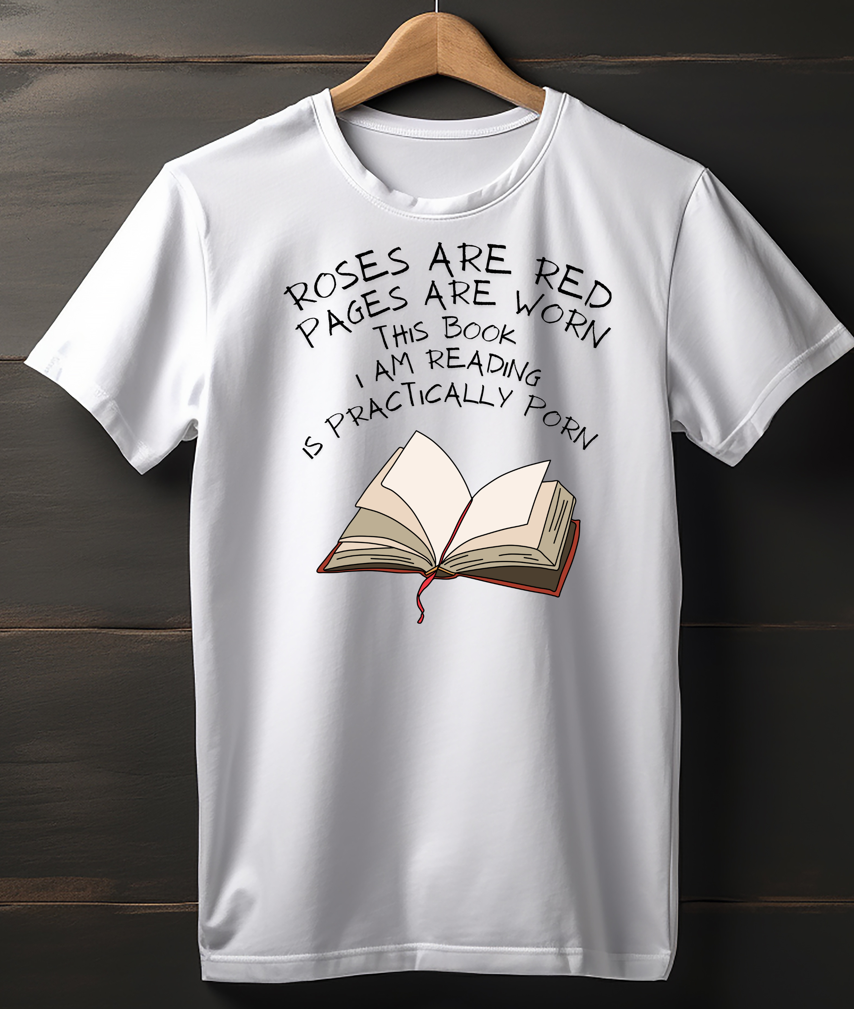 White t-shirt with a book graphic and humorous text on a wooden background